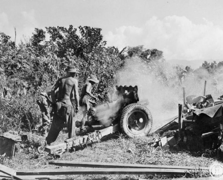 A 3.7-inch howitzer of the 158th Field Artillery Regiment, 36th Infantry Division , in action against Japanese positions south of Mawlu.