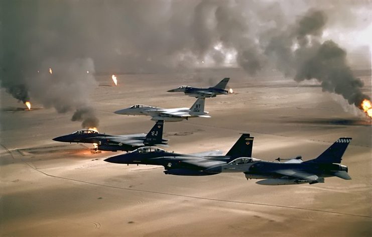 USAF aircraft of the 4th Fighter Wing (F-16, F-15C and F-15E) fly over Kuwaiti oil fires, set by the retreating Iraqi army during Operation Desert Storm in 1991
