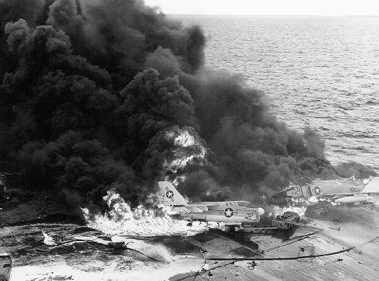 Sailors aboard Enterprise battle a huge ordnance fire triggered by a Zuni rocket. 14 January 1969