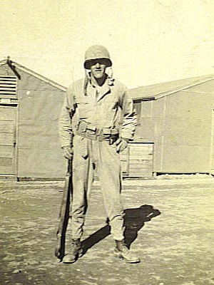 Albert Blithe standing in uniform with his weapon