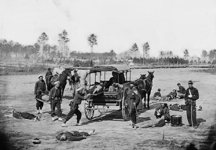American Zouave ambulance crew demonstrating removal of wounded soldiers from the field, during the American Civil War.