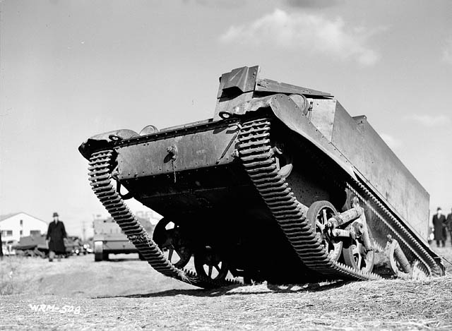 Army vehicle (Universal Carrier) being driven up a slope.Photo BiblioArchives : LibraryArchives CC BY 2.0