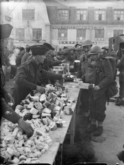 British troops queue for a meal after coming ashore in Norway.