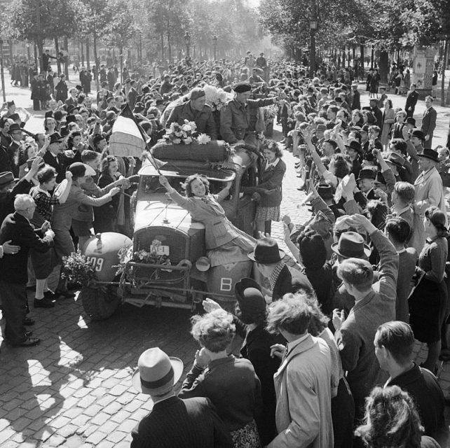 Civilians celebrate as British vehicles enter Brussels, September 4, 1944.