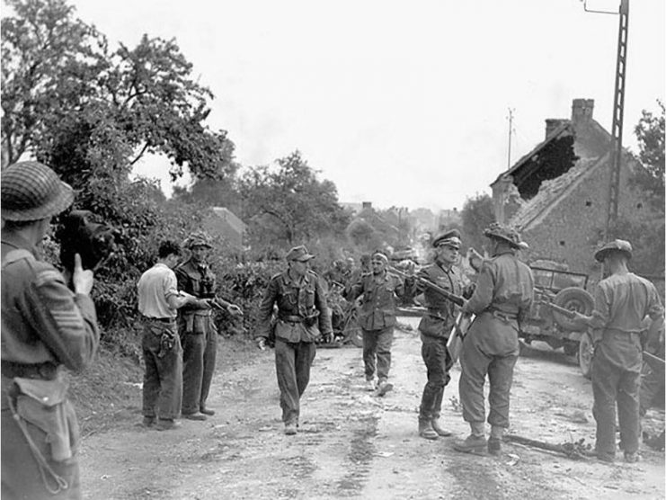 Currie (left of centre, holding a revolver) accepting the surrender of German troops at St. Lambert-sur-Dives, France, 19 August 1944.