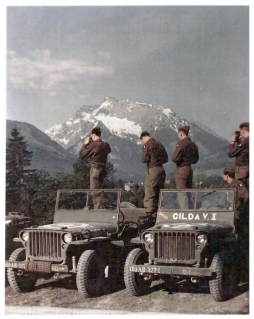 Members of the 101st Airborne standing on military Jeeps