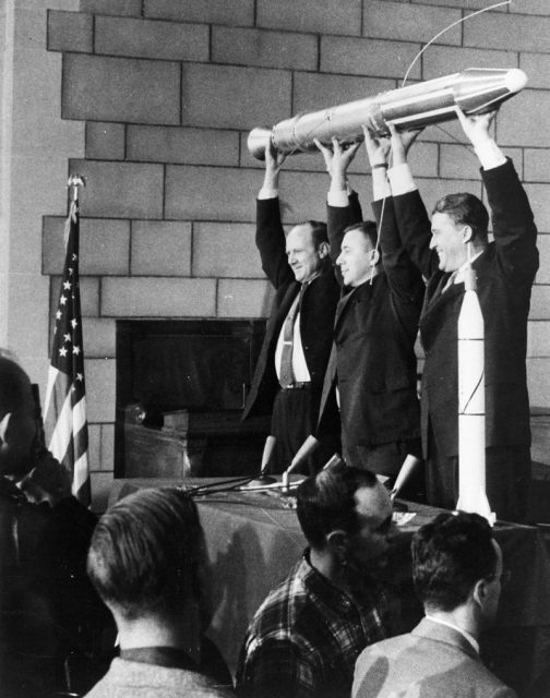 William Hayward Pickering, James Van Allen, and Wernher von Braun display a full-scale model of Explorer 1 at a crowded news conference in Washington, DC after confirmation the satellite was in orbit.