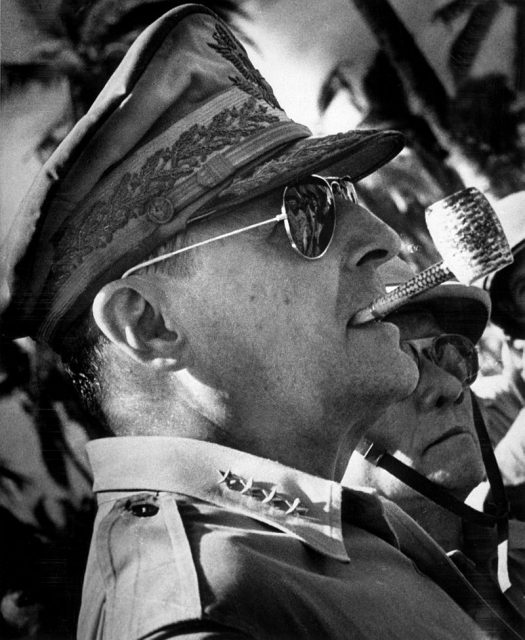 General MacArthur’s signature look included his ornate hat, corncob pipe, and aviator sunglasses. 1944