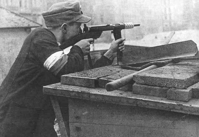 Home Army soldier armed with Błyskawica submachine gun defending a barricade in Powiśle District of Warsaw during the Uprising, August 1944.