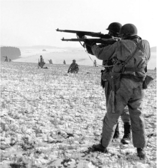Infantrymen fire at advancing German troops to relieve the surrounded paratroopers.