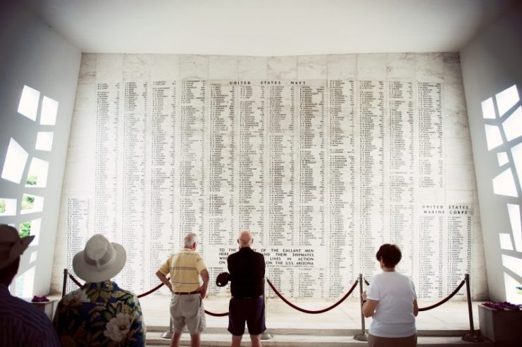 Onlookers look at the Memorial Wall on the remains of the USS Arizona.