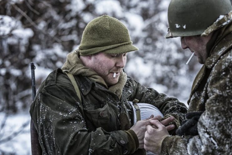 WWII US Army Soldiers Lighting Cigarettes in Windy Winter Snow