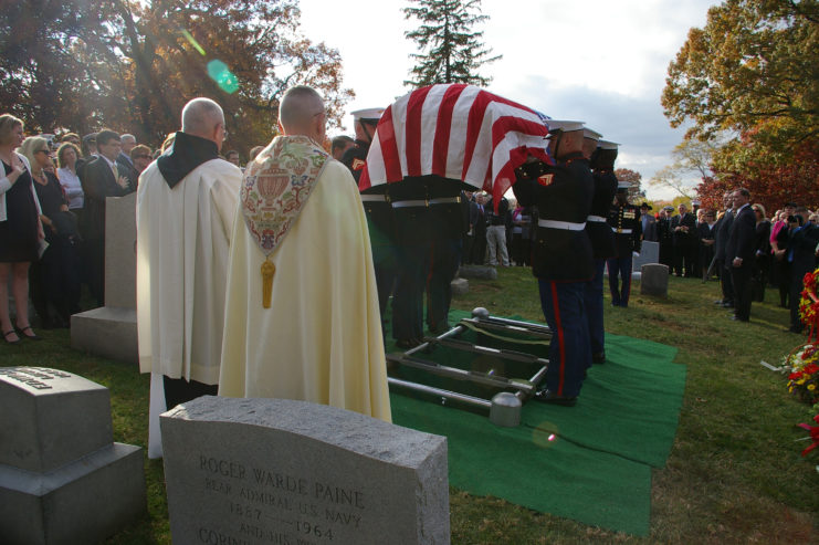 US Marine Corps Body Bearers lowering John Ripley's American flag-draped casket