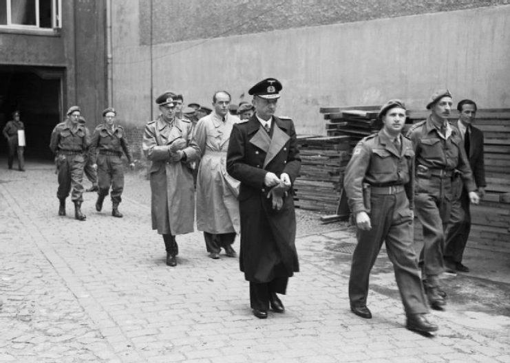 Karl Dönitz (centre, in long, dark coat) followed by Albert Speer (bareheaded) and Alfred Jodl (on Speer’s right) during the arrest of the Flensburg government by British troops