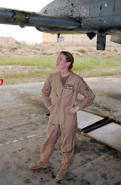 USAF Pilot Kim Campbell looks at her damaged A-10 Warthog which she landed at her base after a mission over Baghdad in 2003.
