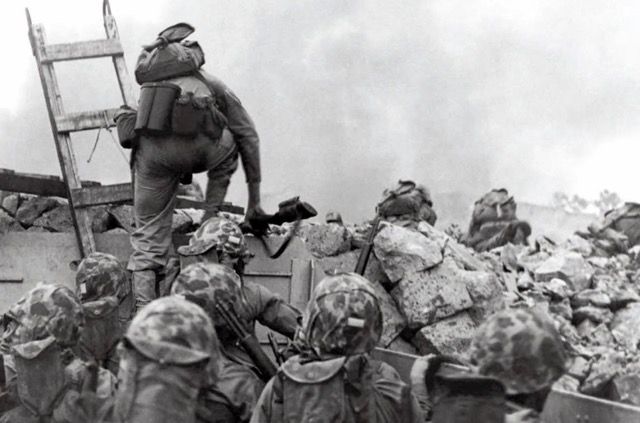 Lt. Baldomero Lopez leading his men over the seawall at Inchon. (Photo credit: USMC)