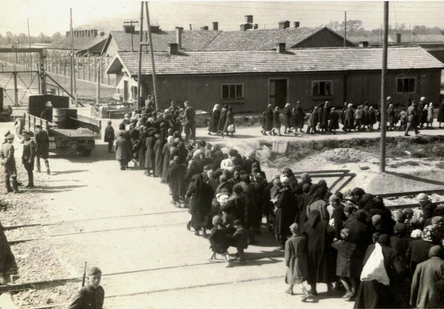 March of new arrivals along the SS barracks at Birkenau toward the gassing bunker near crematoria II and III, 27 May 1944.