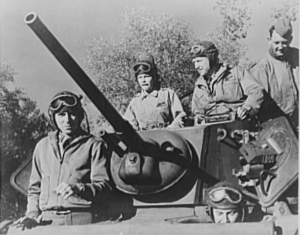 “Martha Raye clowned and sang her way through North Africa, riding in tanks, planes and jeeps and taking shelter during air raids”. Martha Raye (at top left) with tank crew.