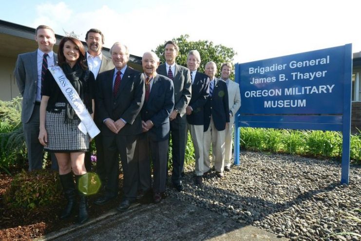 Miss Oregon Nichole Meade joins Oregon State Defense Force Brig Gen. James B. Thayer (second from far right)for a photo in front of the new sign for the Brig. Gen. James B. Thayer Oregon Military Museum at Camp Withycombe in Clackamas, Oregon, April 11 2012