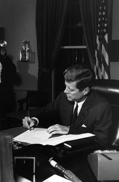 President Kennedy signs the Proclamation for Interdiction of the Delivery of Offensive Weapons to Cuba.