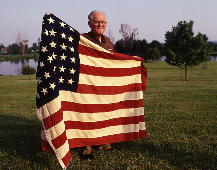 Richard Winters holding up the American flag