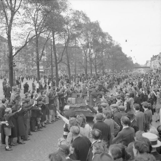 Scenes of jubilation as British troops liberate Brussels, September 4, 1944. A carrier crewed by Free Belgian troops is welcomed by cheering civilians.