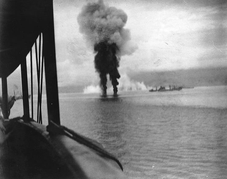 Smoke rises from two Japanese aircraft shot down off Guadalcanal on 12 November 1942.