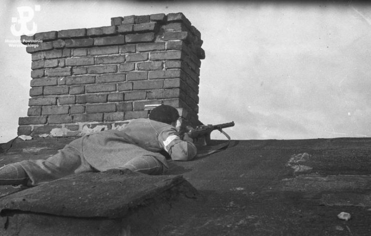 Soldier from “Pięść” Battalion led by Stanisław Jankowski “Agaton,” pictured on a rooftop of a house near the Evangelic Cemetery in Wola District of Warsaw, August 2, 1944.