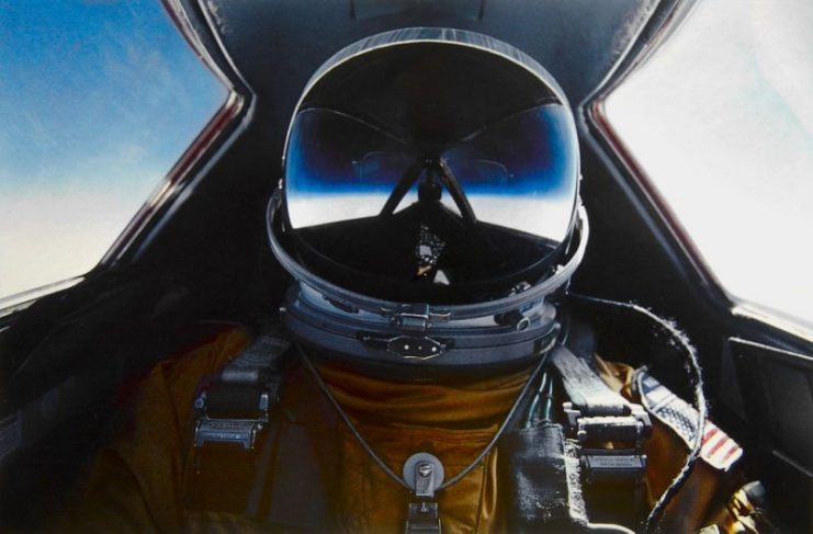 A self-portrait of Brian Shul in full flight suit gear within the cockpit of the SR-71 Blackbird.