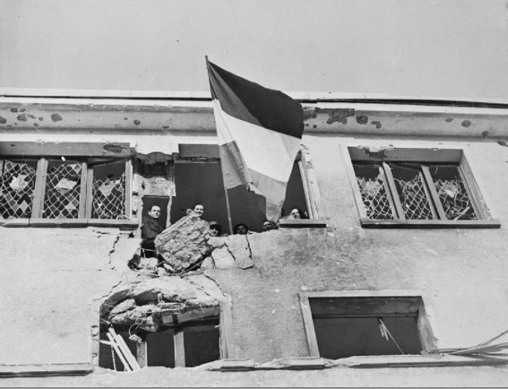 The Flag of Luxembourg flying from the Hospital in Wiltz shortly after its liberation by the American 4th Armoured Division, December 25, 1944.