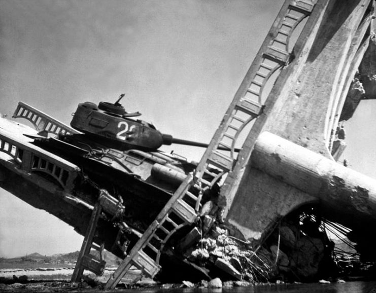 The wreckage of a bridge and North Korean T-34-85 tank south of Suwon, Korea.