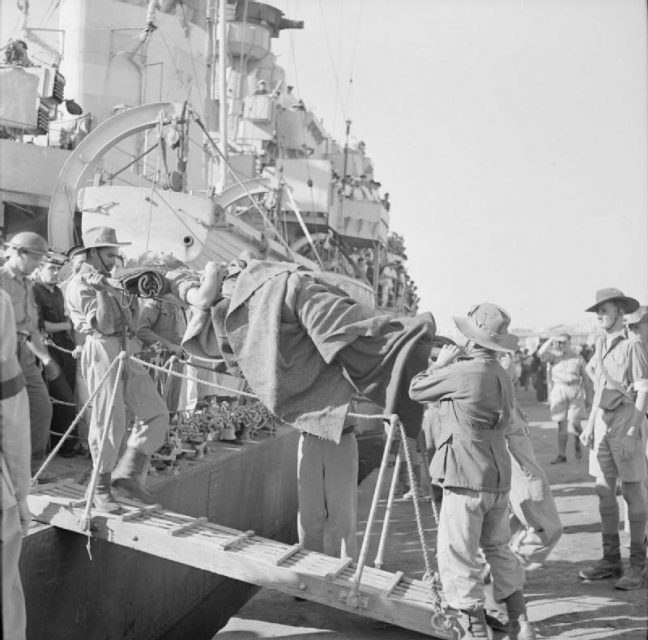 Evacuation: A wounded soldier being brought ashore on a stretcher at an Egyptian port after the evacuation from Crete. A total of 16,500 were rescued , including 2000 Greeks. The rest were left dead or prisoners in German hands.