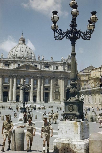 Three British soldiers walk across St Peter’s Square after attending a service in the church.