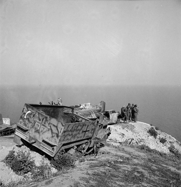 US troops with abandoned German equipment including an M3 halftrack May 1943.