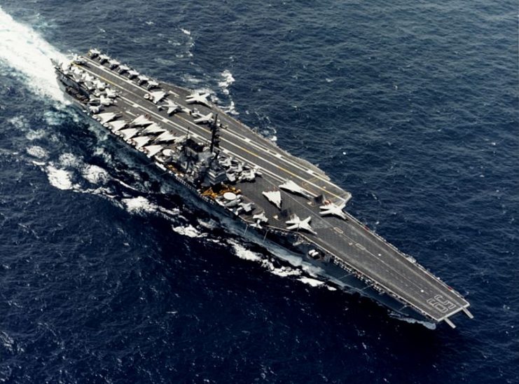 The U.S. Navy aircraft carrier USS Forrestal (CV-59) underway at sea in 1987. Various aircraft of Carrier Air Wing 6 (CVW-6) are visible on deck