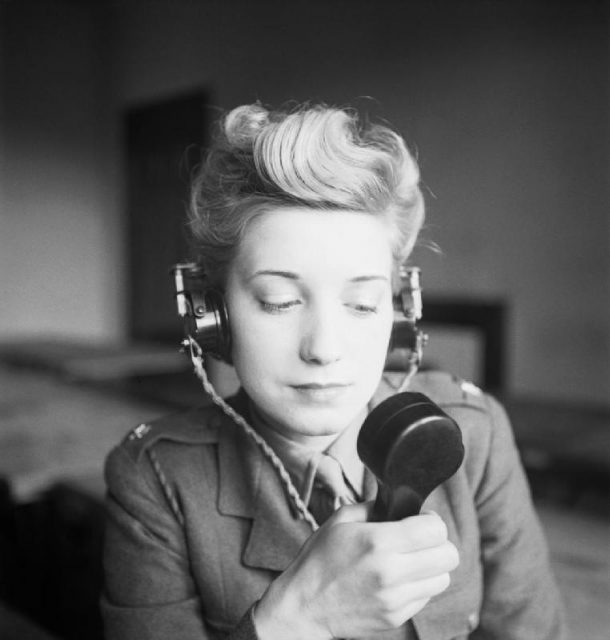 Female radio operator, transmitting a radio message, WWII.