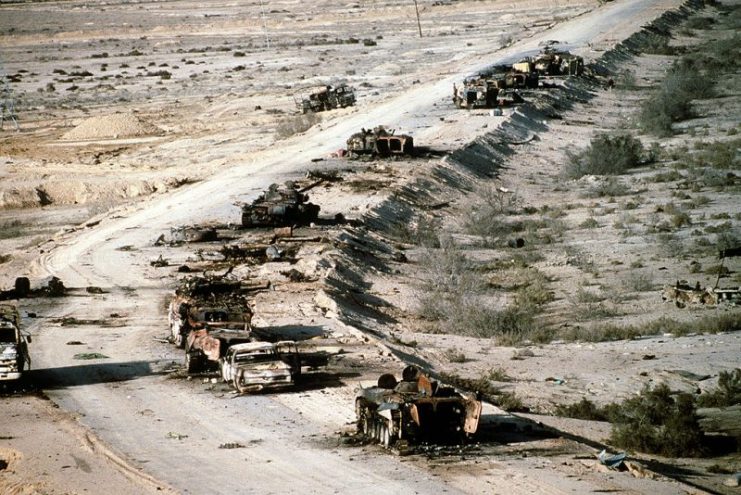 Liberation of Kuwait: Aerial view of destroyed Iraqi T-72 tank, BMP-1 and Type 63 armored personnel carriers and trucks.