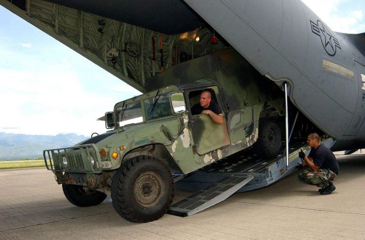 A high humvee inside of a C-130J aircraft