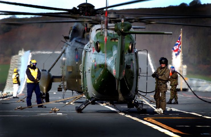 Lynx helicopter is being refuelled on the flight deck of HMS Ark Royal during the DISTEX