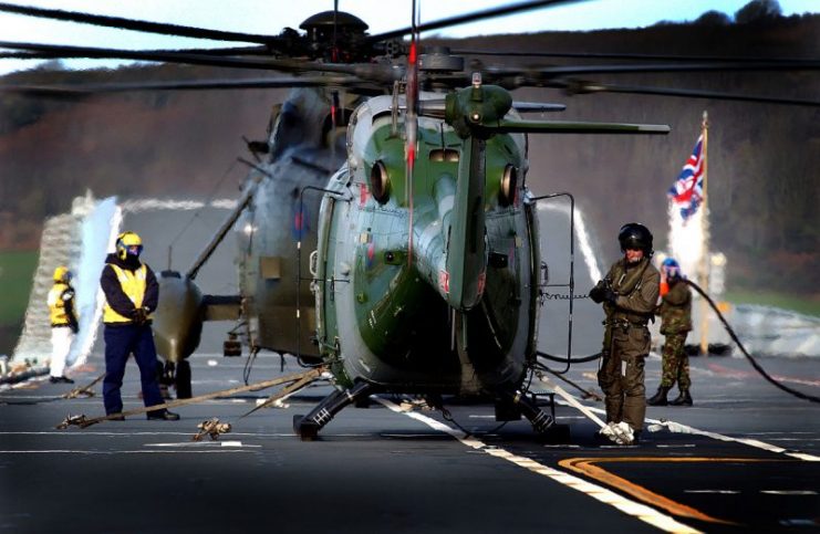 Lynx helicopter is being refuelled on the flight deck of HMS Ark Royal during the DISTEX