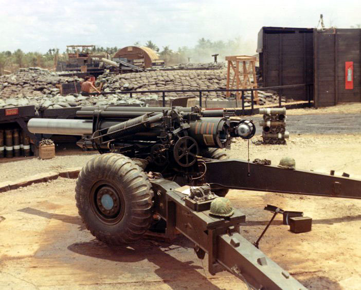Side view of a 155mm howitzer in a fortified firing position
