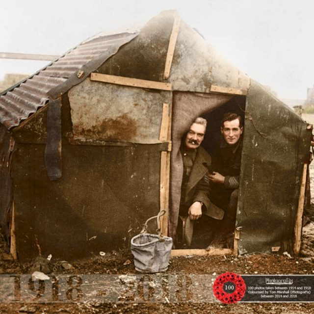 39. ‘Their home on the Somme.’ Two officers looking out of a small shelter they appear to have made for themselves.