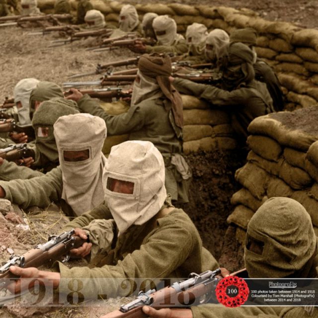 63. A group of Indian soldiers armed in a trench, 1915. The hoods they are wearing are gas masks; the First World War was the first war in which manufactured poison gas was used as a weapon on a large scale. Original photo by H.D. Girdwood, courtesy of the British Library. Originally colourised for the Open University.