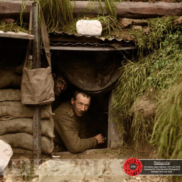 66. Two New Zealand soldiers look out of a dugout at the front line, Hebuterne in France.