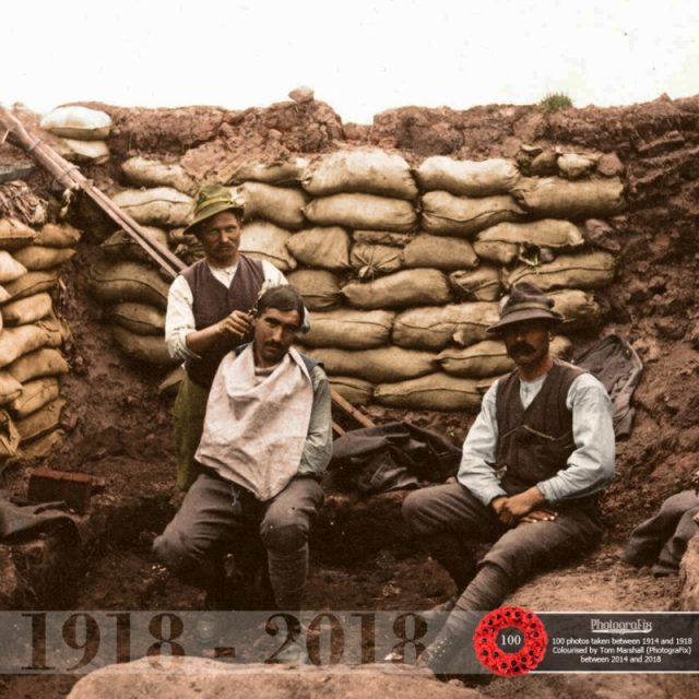 81. A soldier receives a haircut from an Alpine barber on the Albanian front. Originally colourised for the Open University.