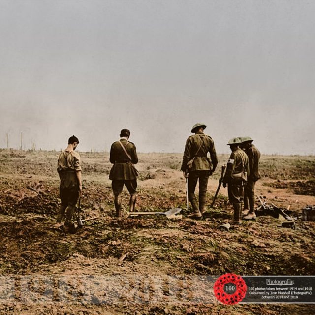 93. An army chaplain conducts a burial service while a burial party stand, paying their respects, at the Battle of Guillemont, 4th September 1916.