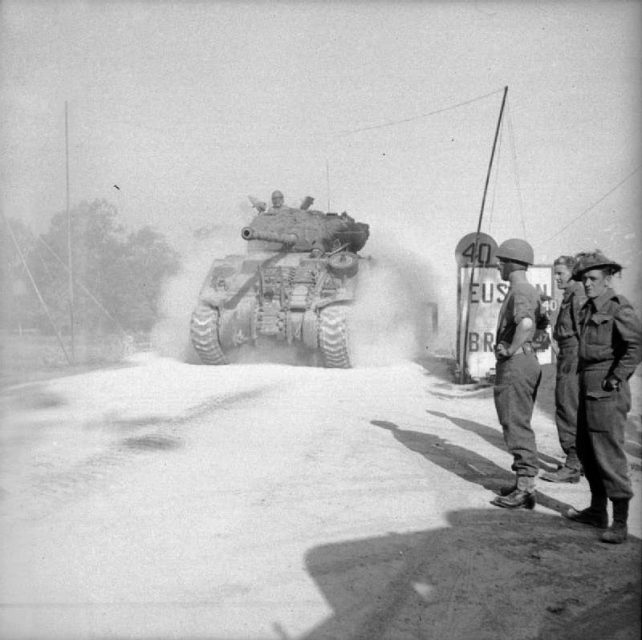A Sherman Firefly crosses ‘Euston Bridge’ over the Orne as it moves up to the start line for Operation Goodwood, 18 July 1944