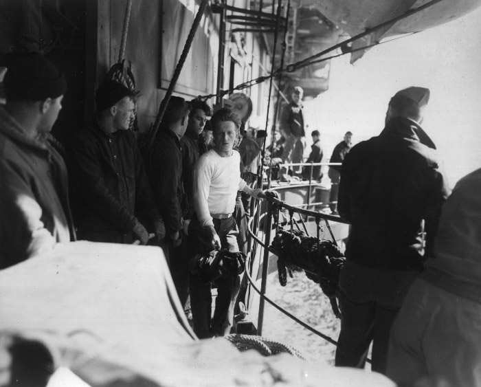 A survivor of the German submarine U-546 comes aboard USS Bogue