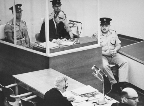 Adolf Eichmann takes notes during his trial