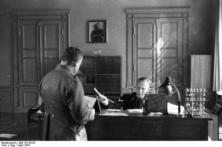 Reinhard Heydrich in his office. By Bundesarchiv – CC BY-SA 3.0 de